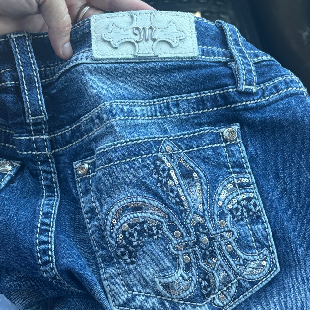 Miss Me 34” Boot Cut Jeans with Silver Fleur de Lis pockets